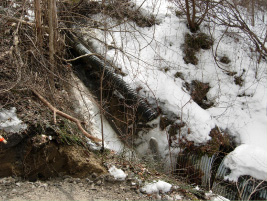 Eroding stormwater outfall pipe and damaged culvert
